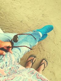 Low section of man legs on sand at beach