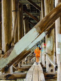 Rear view of man working on bridge