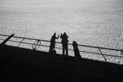 Shadow of people on sea shore