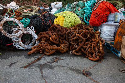 High angle view of fishing nets with rusty chains on street