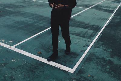 Low section of man standing on street