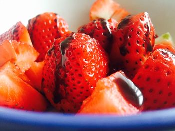 Close-up of chopped strawberries with chocolate sauce in bowl