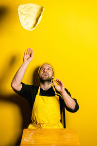 Chef preparing food against colored background