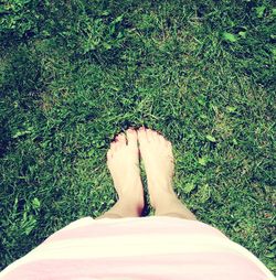 Low section of woman relaxing on grass