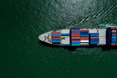 High angle view of shipping containers sailing on sea green