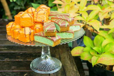 Close-up of cake on stand by plants