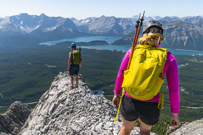 Couple hiking together on mountain ridgeline above kananaskis alberta