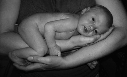 Portrait of cute baby boy lying on bed