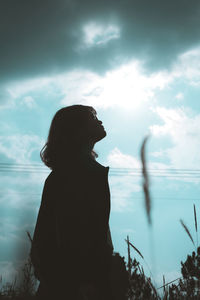 Silhouette woman looking at view of sky