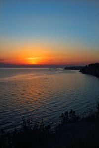 Scenic view of sea against romantic sky at sunset