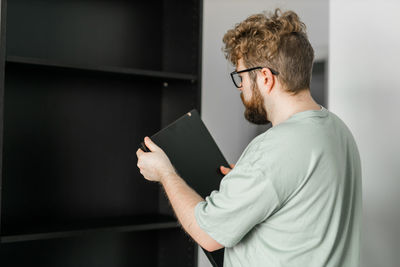 Side view of man using digital tablet in office