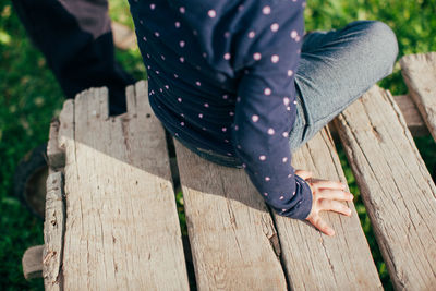 Low section of woman standing on wood