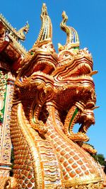 Low angle view of statue against temple building