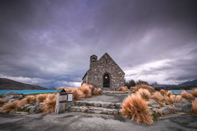 Chapel against cloudy sky at dusk