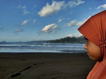 Close-up of girl wearing hijab while looking at sea