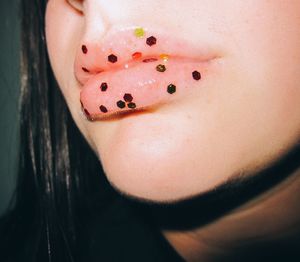 Close-up of woman with lemon slice