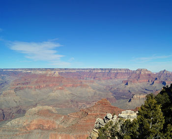 Scenic view of mountains against blue sky