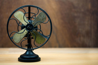 Retro electric fan on wood table with copy-space.