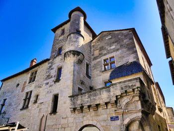 Low angle view of old building against blue sky