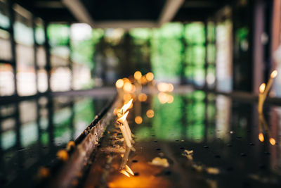 Close-up of illuminated railroad tracks at night