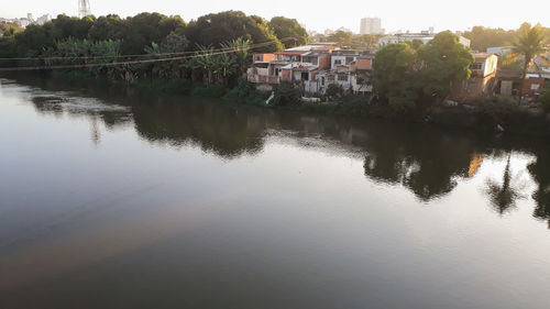 Scenic view of lake by buildings against sky