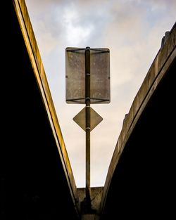 Low angle view of street light against building