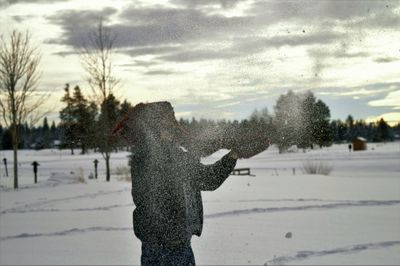 Person standing on snow covered field