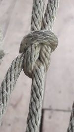 Close-up of rope tied up on wood