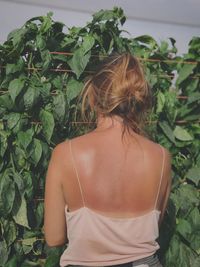 Rear view of woman standing by plants