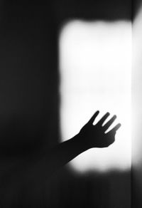 Close-up of hand on glass window