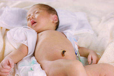 Baby girl lying on bed