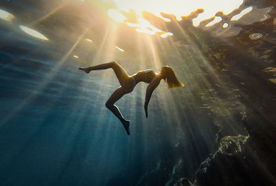 Low angle view of woman swimming in sea