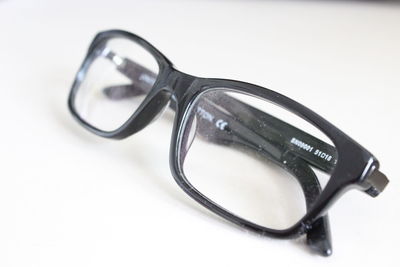 Close-up of sunglasses on table against white background