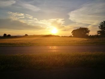 Scenic view of field against sky during sunset