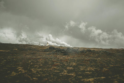 Smoke emitting from volcanic mountain against sky