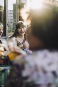 Cheerful transgender woman enjoying with non-binary friend