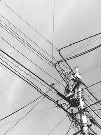 Low angle view of electricity pylon against sky