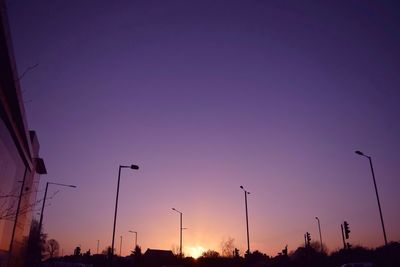 Low angle view of street light against blue sky