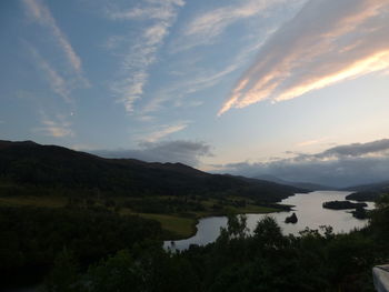 Scenic view of lake against sky at sunset