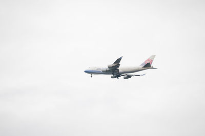 Low angle view of airplane flying against clear sky