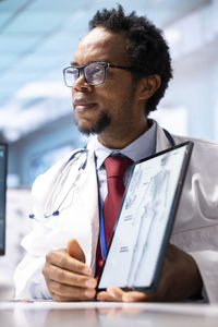 Portrait of businessman using digital tablet