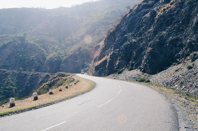 Country road leading towards mountains