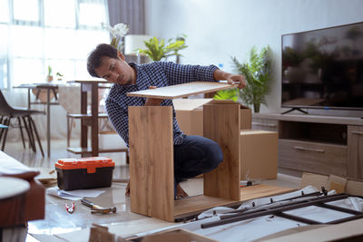 Side view of woman working at home