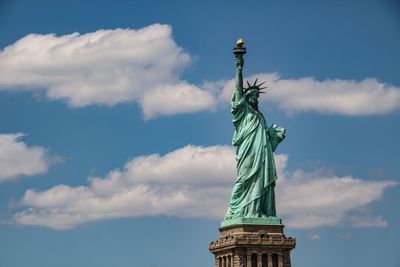 Low angle view of statue against cloudy sky