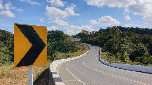 Road sign against sky