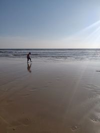 Man on beach against sky