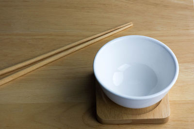 Ceramic white bowl isolated on the wood table