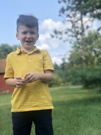 Happy boy standing on field