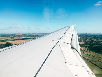 Airplane wing against sky