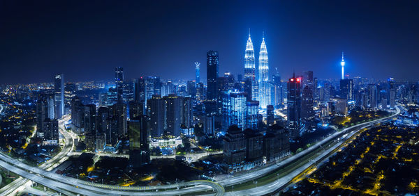 High angle view of city lit up at night